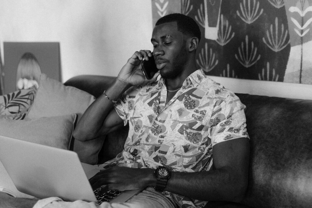 Man in Floral Button Up Shirt Sitting on Couch